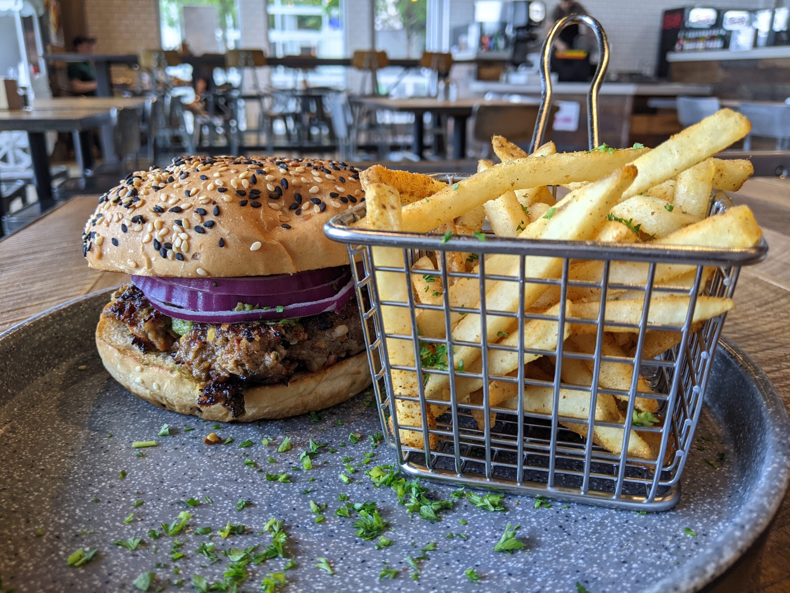 A chapli kebab burger and fries at Adda