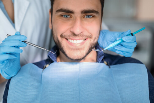 man smiling before dentist checks teeth
