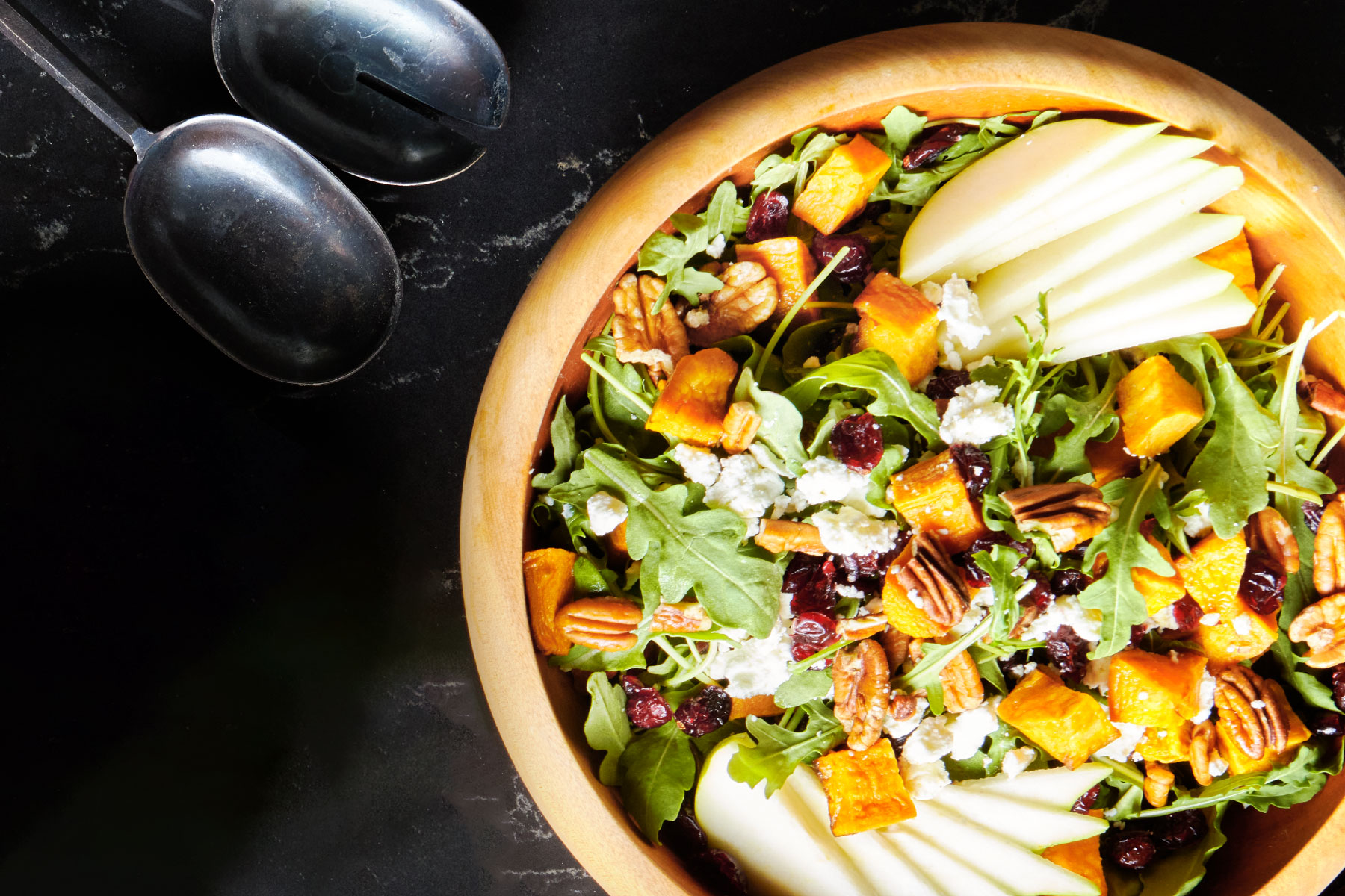 Arugula, sweet potato, pear, and dried cranberry salad with a maple-mustard dressing